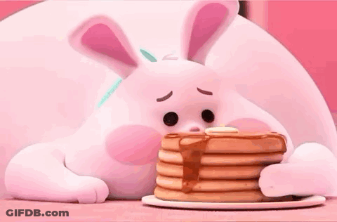 A Bunny Is Eating A Stack Of Pancakes With Syrup . GIF