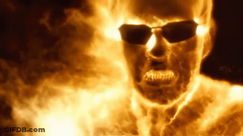 A Burning Man Wearing Sunglasses Is Surrounded By Flames GIF