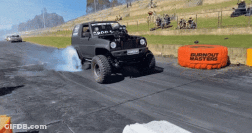 A Burnout Masters Bag Is On The Side Of A Road GIF