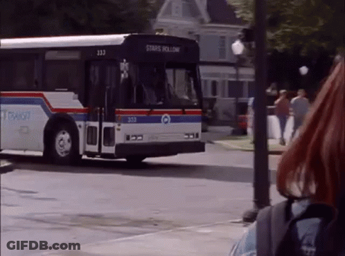 A Bus That Says Stars Hollow Is Driving Down The Street GIF