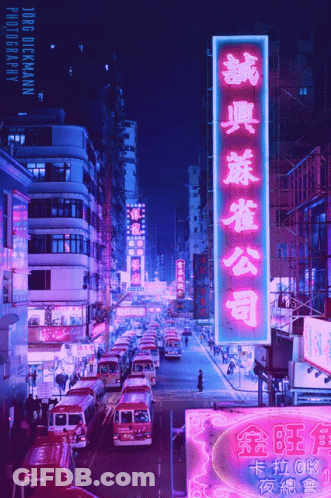 A Busy City Street With A Neon Sign That Says Jorge Dickmann GIF