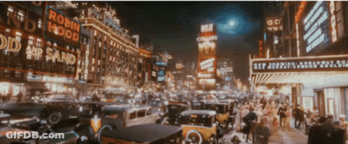 A Busy City Street With A Robin Hood Sign GIF
