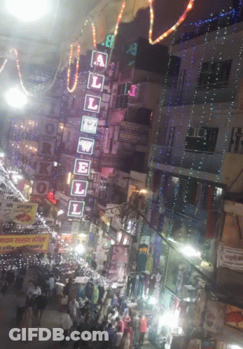 A Busy Street With A Sign That Says A L E W E L On It GIF