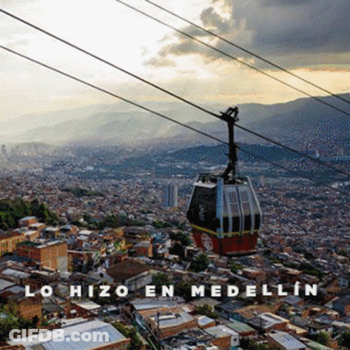 A Cable Car Going Over A City With The Words Lohizo En Medellin Written Below It GIF