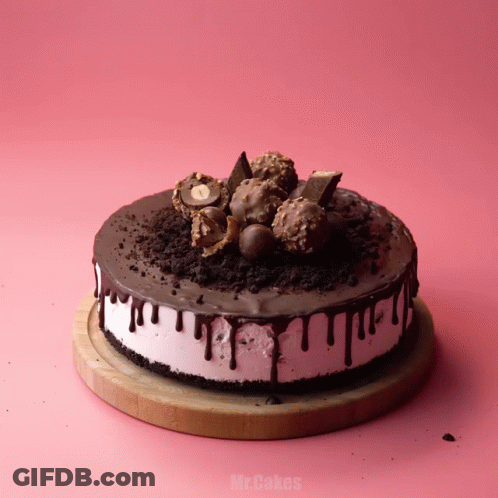 A Cake On A Wooden Cutting Board That Says Mr.cakes On It GIF
