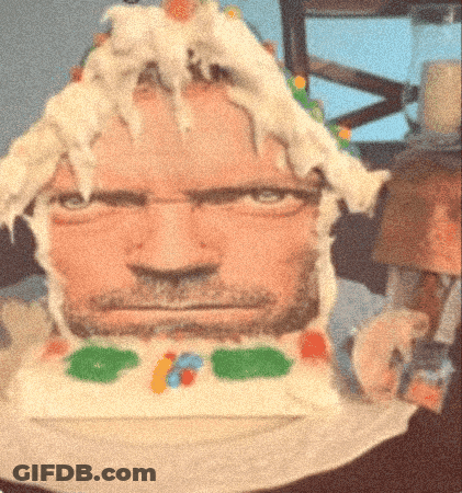A Cake That Looks Like A Man 'S Face With A Beard On It GIF