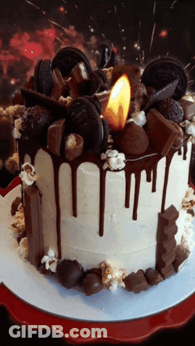A Cake With A Candle On Top Of It That Says Oreo On It GIF