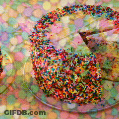 A Cake With A Slice Taken Out Of It And Sprinkles On Top GIF