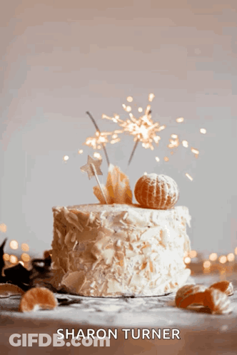 A Cake With Sparklers On Top Of It And The Name Sharon Turner GIF