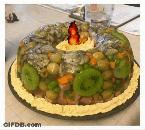 A Cake With Vegetables And A Fire On Top GIF