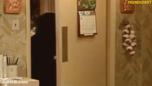 A Calendar Is Hanging On The Wall Next To A Door GIF