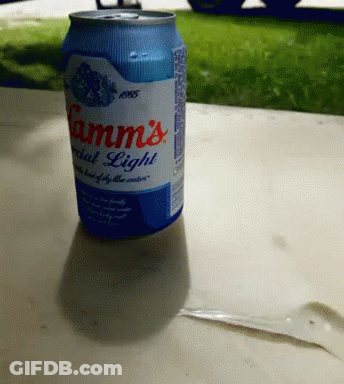 A Can Of Camm 'S Special Light Beer Sits On A Table Outside GIF