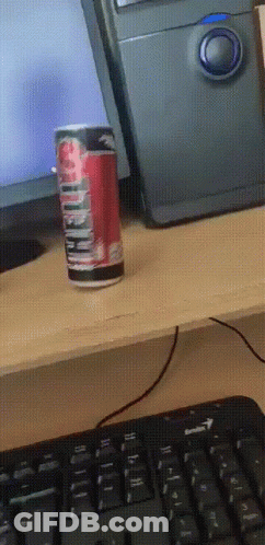 A Can Of Diet Coke Sits On A Desk Next To A Computer GIF