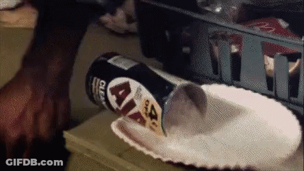 A Can Of Lays Chips Is Being Poured Into A Paper Plate On A Table GIF