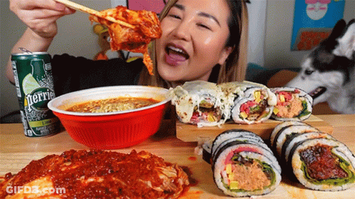 A Can Of Perrier Sits On A Table With A Woman Eating Food GIF