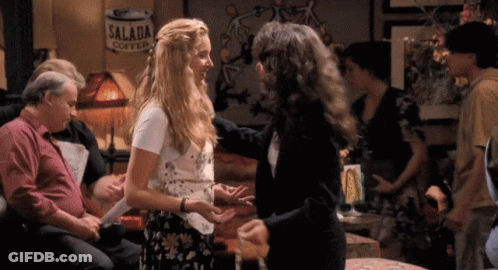 A Can Of Salada Coffee Is Hanging On The Wall Behind Two Women GIF