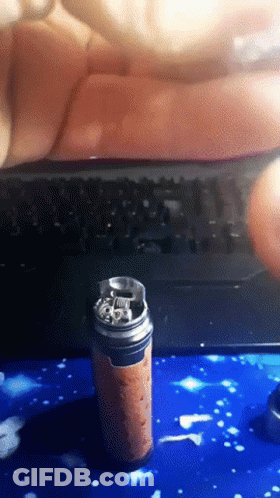 A Can Of Soda Sits On A Blue Surface In Front Of A Computer Keyboard GIF