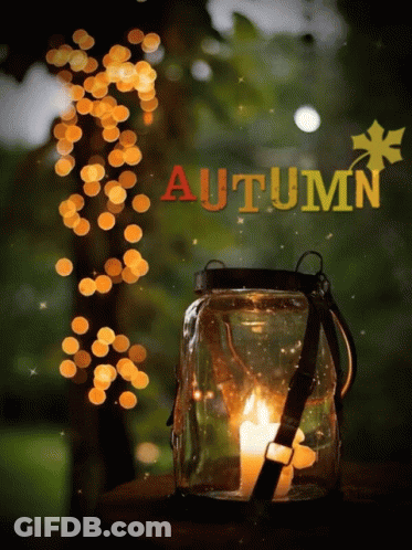 A Candle In A Jar With The Word Autumn On The Bottom GIF