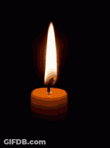 A Candle Is Lit Up In The Dark And Has A Single Flame GIF