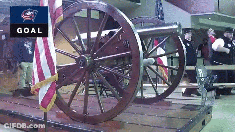 A Cannon Is On Display In Front Of An American Flag And A Goal Sign GIF