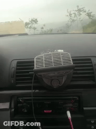 A Car Dashboard With A Sony Radio And A Fan Attached To It GIF