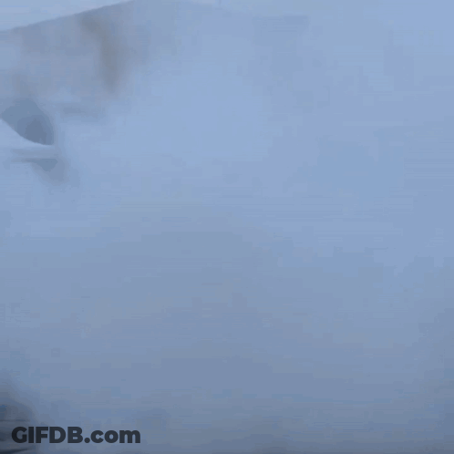 A Car Is Doing A Burnout In A Parking Lot With Smoke Coming Out Of It GIF