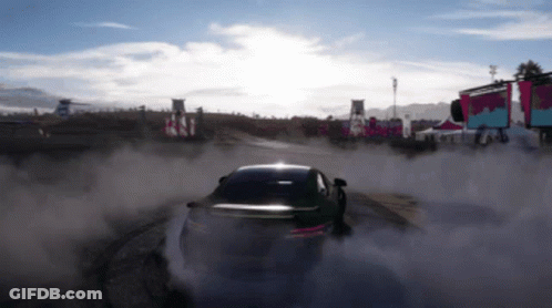 A Car Is Drifting On A Dirt Track With Smoke Coming Out Of It GIF