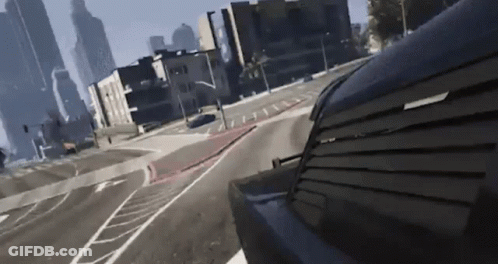 A Car Is Driving Down A City Street With A Few Buildings In The Background GIF