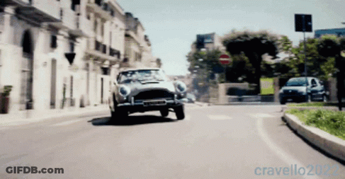 A Car Is Driving Down A City Street With The Year 2022 On The Bottom Right GIF