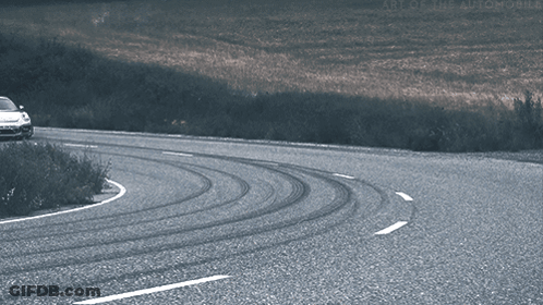 A Car Is Driving Down A Curvy Road With The Words Art Of The Automobile On The Bottom Right GIF