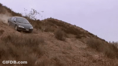 A Car Is Driving Down A Dirt Hill With A License Plate That Says ' Jc ' GIF