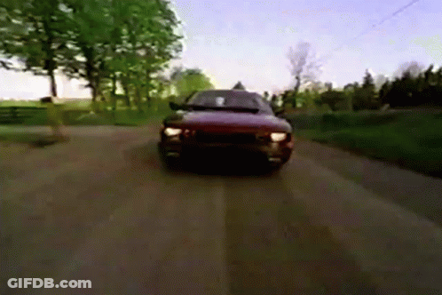 A Car Is Driving Down A Dirt Road In The Countryside GIF