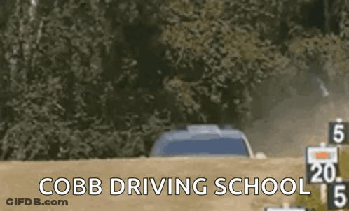 A Car Is Driving Down A Dirt Road With The Words Cobb Driving School In The Corner GIF