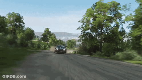A Car Is Driving Down A Dirt Road With Trees On The Side GIF