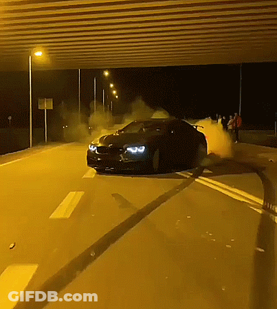 A Car Is Driving Down A Highway At Night GIF