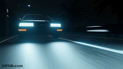 A Car Is Driving Down A Highway At Night GIF