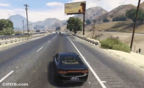 A Car Is Driving Down A Highway In Front Of A Billboard GIF