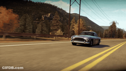 A Car Is Driving Down A Highway With Mountains In The Background GIF