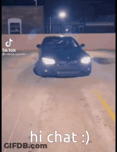 A Car Is Driving Down A Parking Lot At Night And The Caption Says Hi Chat . GIF