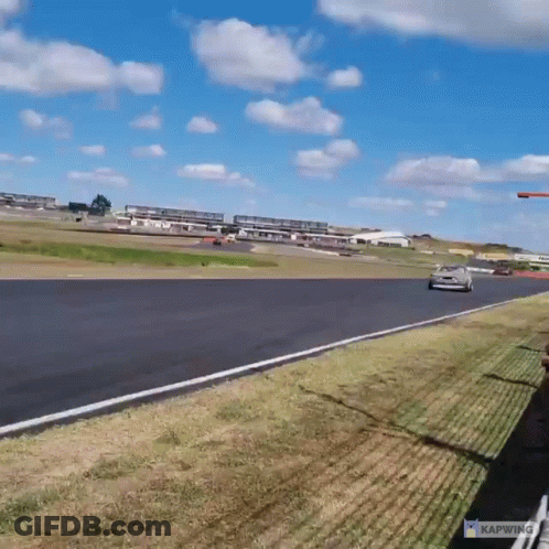 A Car Is Driving Down A Race Track With The Word Kapwing On The Bottom GIF
