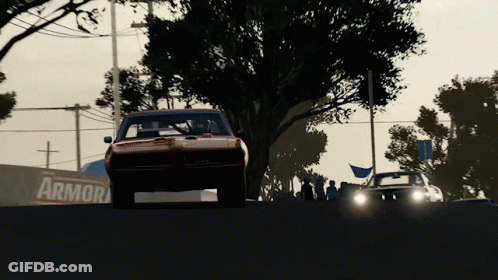 A Car Is Driving Down A Road In Front Of A Sign That Says Armora GIF