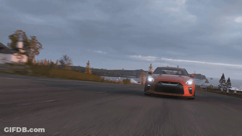 A Car Is Driving Down A Road With A House In The Background GIF
