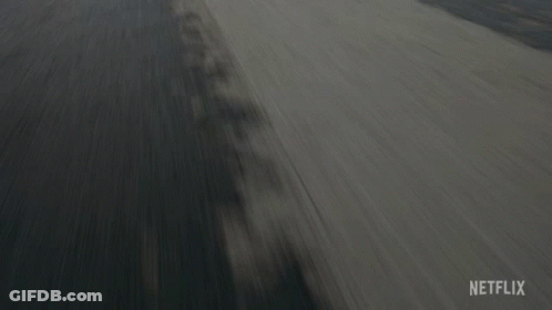 A Car Is Driving Down A Road With A Netflix Logo On The Bottom Right GIF