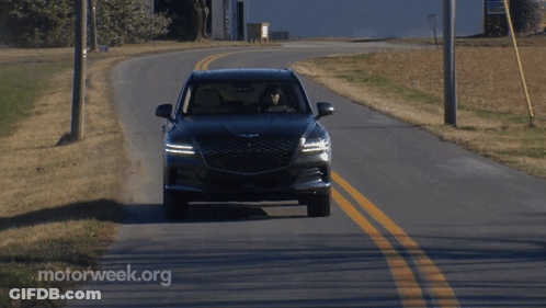 A Car Is Driving Down A Road With Motorweek.org Written On The Side GIF