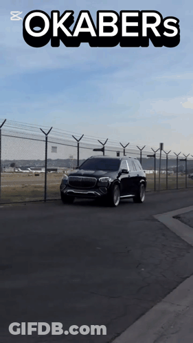 A Car Is Driving Down A Road With Okabers Written On The Top GIF