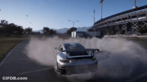 A Car Is Driving Down A Road With Smoke Coming Out Of The Tires GIF