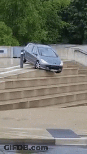 A Car Is Driving Down A Set Of Steps GIF