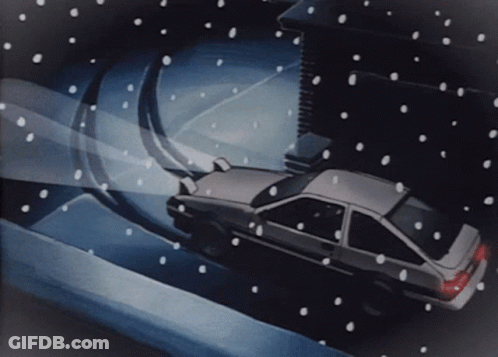 A Car Is Driving Down A Snowy Road GIF