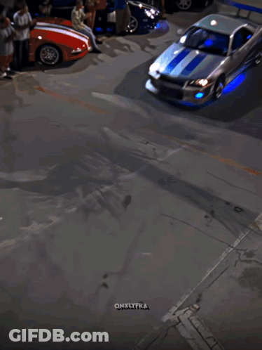 A Car Is Driving Down A Street In Front Of A Miami Sign GIF