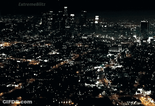A Car Is Driving Down A Street With A Sign That Says Extremeblitz On It GIF